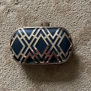 Black and gold clutch. Pretty front design. Hard exterior.